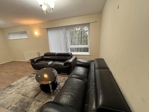 A living room with a sectional sofa, a coffee table, and a radiator. - Kingbeds/liverpoolcity/freep/wm/fastwifi (Liverpool)