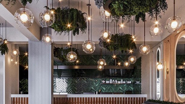 A restaurant interior with wooden tables and chairs, hanging pendant lights, and a herringbone patterned floor. - The Port Palace Otel (Istanbul)