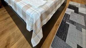 A modern bedroom with a large bed, a wooden slat wall, and a built-in shower. - The Port Palace Otel (Istanbul)