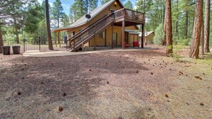 A cabin with a covered porch, a staircase, and a fenced yard. - 1 Mi to Lake: Pet-friendly Arizona Gem (Lakeside)