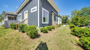 A two-story house with a grey exterior, a front porch, and a well-maintained lawn. - 3 Mi to Duke: Downtown Durham Cottage! (Durham)