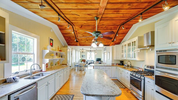 A spacious kitchen with white cabinets, a granite countertop, and a wooden ceiling. - Home w/ Fire Pit < 1 Mi to Willis Wharf Boat Ramp! (Exmore)