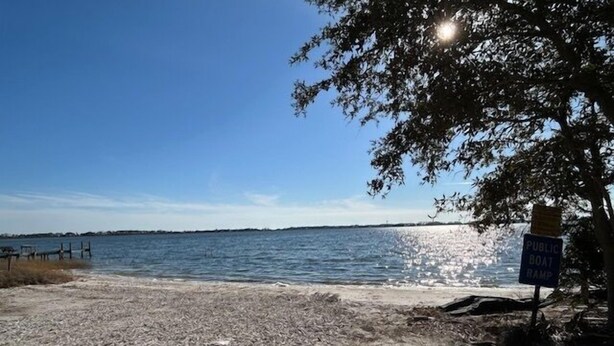 A beach with a public boat ramp and a clear view of the water.