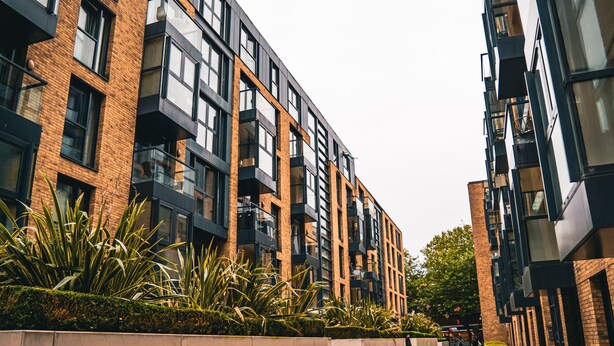 A modern multi-story building with a brick facade, large windows, and balconies. - Birmingham City Centre Apartment, Free Parking (Birmingham)