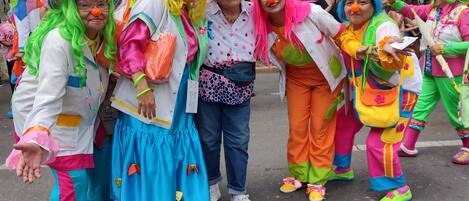 A group of people in colorful costumes standing on a street.