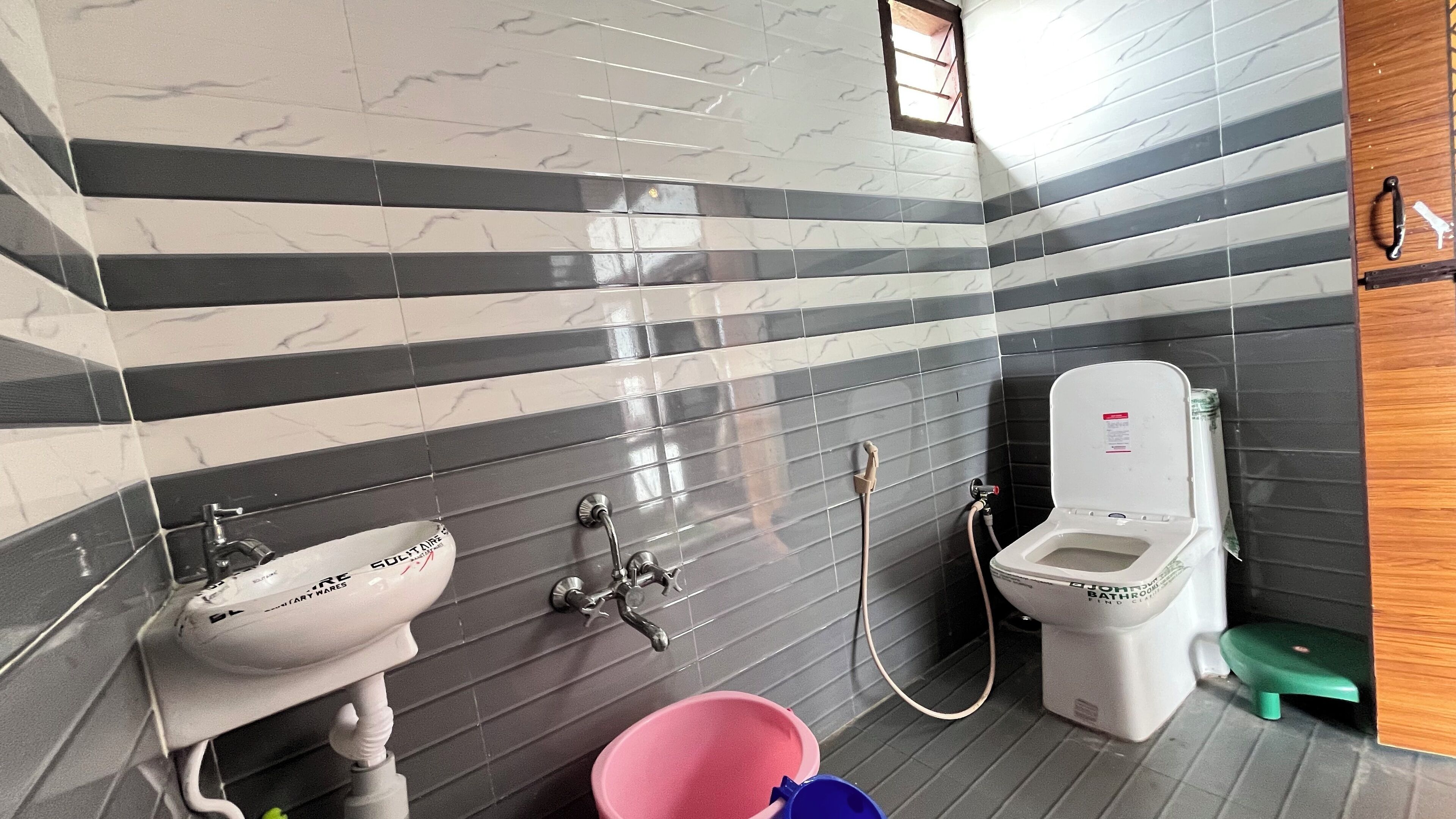 A bathroom with a sink, toilet, and shower.