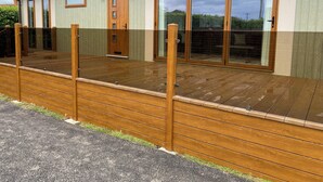 A modern house with a wooden deck, large sliding glass doors, and a small window. - Tranquil Lodge Retreat in Wells (Wells)