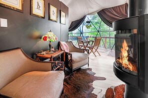 A cozy room with a sofa, a table with a lamp, and a fireplace.