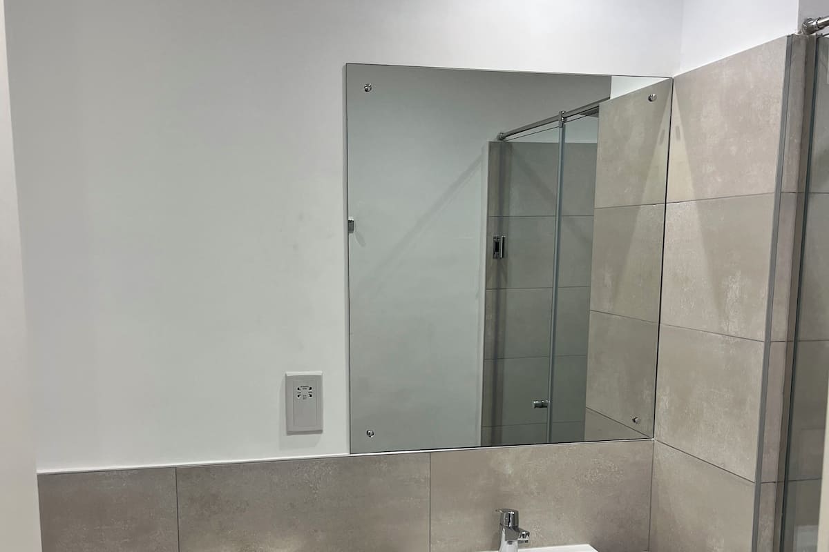 A modern bathroom with a toilet, bidet, and sink.