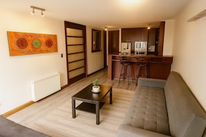 Deluxe Apartment | Living area | Flat-screen TV