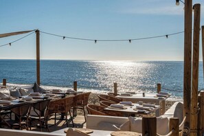 An outdoor dining area with tables and chairs, overlooking the sea. - Casa Magnolia | Ref. #83 (Marbella)