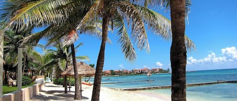 Private beach, white sand, sun loungers, beach umbrellas