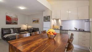 A modern kitchen with white cabinets, a microwave, and a gas stove. - Golden Eagle 1 - Central Village (Central Village)