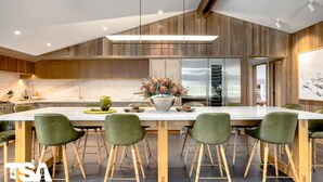A modern kitchen with a large island, wooden cabinetry, and a central light fixture. - Sequoia 5 Penthouse - Central Village (Central Village)