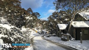 A snow-covered rural road with stone houses on either side. - Sneznik - Central Villaage (Central Village)