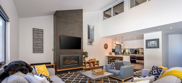 Cozy living space with a fireplace, flat-screen TV, and comfortable seating area.