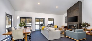 Cozy living space with a fireplace, dining table, and comfortable seating area.