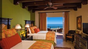 A hotel room with two beds, a balcony with a view of the ocean, a ceiling fan, and a television. - Cabos Montecristo Villa w/ unobstructed breathtaking ocean view (Cabo San Lucas)