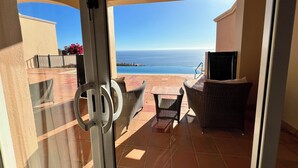 A view from a balcony with a pool, outdoor furniture, and a sign for Montecristo Estates in Puerto Bonito. - Cabos Montecristo Villa w/ unobstructed breathtaking ocean view (Cabo San Lucas)
