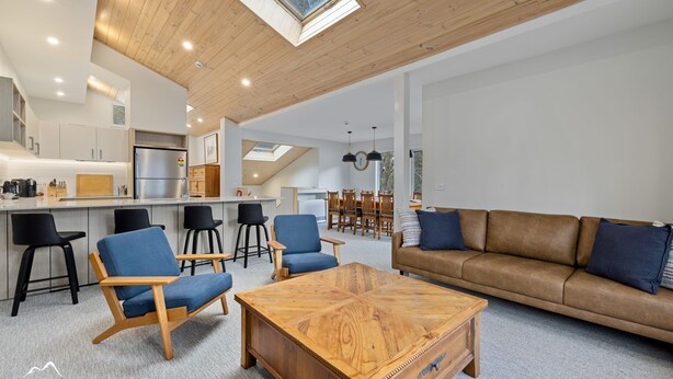 A modern living space with a kitchen, dining area, and seating area.