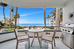 Enjoy ocean views from this balcony with a round table and two chairs, perfect for al fresco dining.