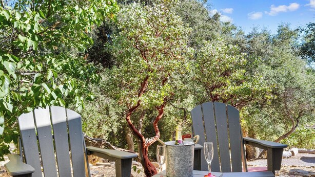 Two Adirondack chairs with a table and a bucket of ice between them. - Julian Cafe Couples Cottage - Breakfast Included at The Julian Cafe & Bakery! (Julian)