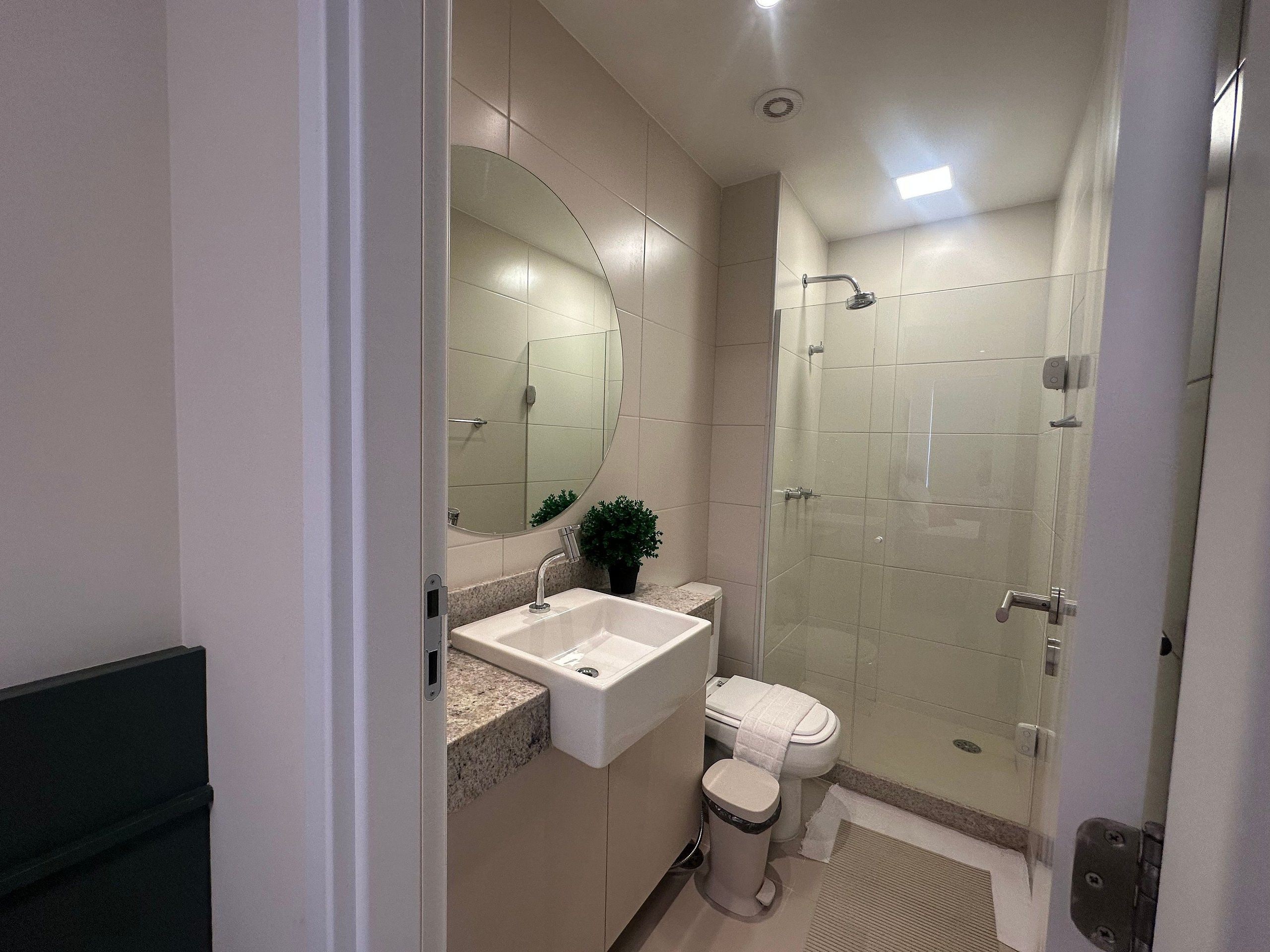 Un bany modern amb un lavabo, vàter i plat de dutxa.