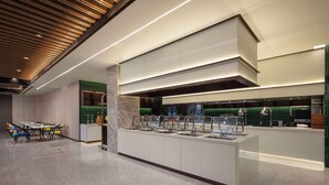 A modern hotel lobby with a long reception desk, multiple seating areas, and a well-lit ceiling with linear lighting. - Days Hotel By Wyndham Nanchang Tengwangge (Nanchang)