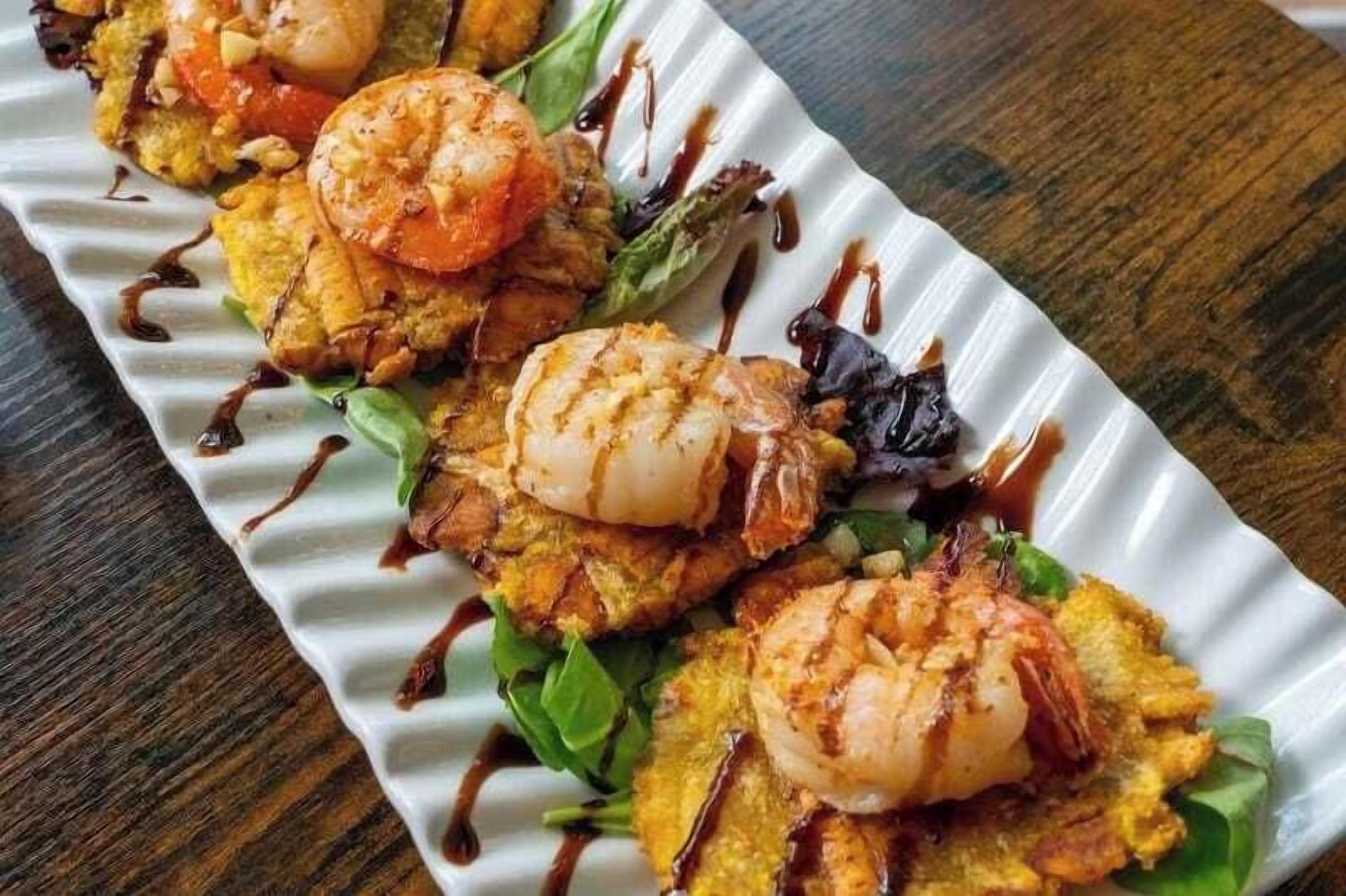 A dish with shrimp and vegetables on a plate.