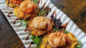 A dish with shrimp and vegetables on a plate.