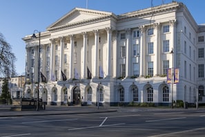 A large, classical building with columns and arched windows, labeled "The Queen's Hotel." - Stunning 5 Bed Regency Home (Gloucestershire)