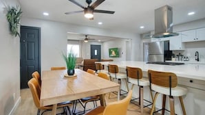 A modern kitchen with white cabinets, stainless steel appliances, and a central island. - Tempe Getaway w/Pool & Near ASU! (Tempe)