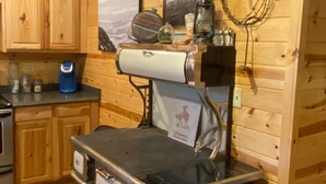 A kitchen with wooden cabinets, a stove, and a refrigerator. - Cozy Ranch Apartment, perfect for hunting season, or a fun weekend getaway. (Winnemucca)