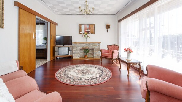 A living room with a fireplace, a television, and a large window. - Villa Fiore- South Fremantle Retro Style (Beaconsfield)