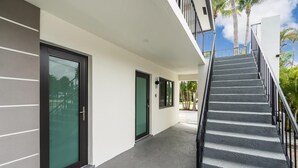 A modern building with a covered walkway, a staircase, and a door with a glass panel. - Modern 2/1 rent near Las Olas Fort Lauderdale (Fort Lauderdale)