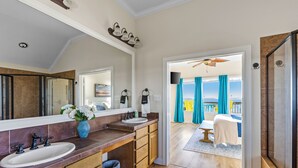 A bathroom with a large mirror, two sinks, and a shower. - Spacious Getaway | Gulf Views & Gameroom Fun (Gilchrist)