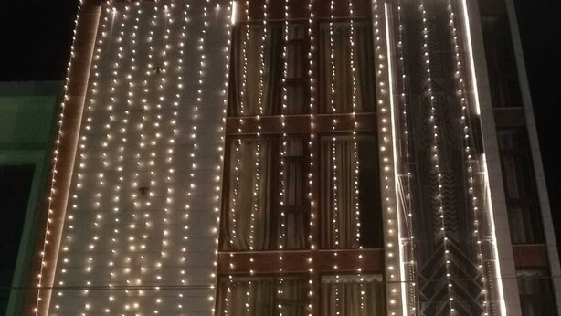 A building with a neon sign reading "Gatsby Hotel" and string lights. - Gatsby Hotel Jaipur (Jaipur)