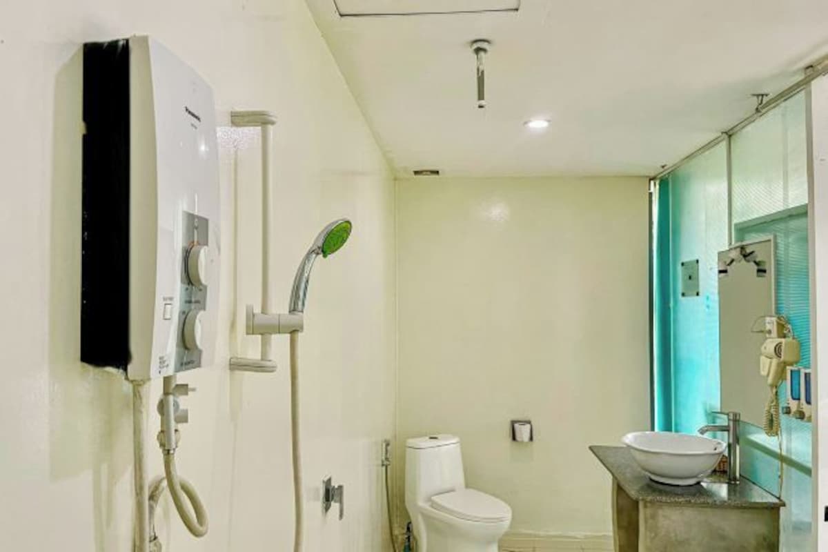 Ein Badezimmer mit Toilette, Waschbecken, Dusche und Spiegel.