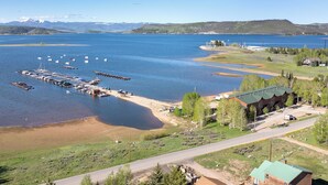 A lakeside property with a dock, a small building, and a road leading to it. - Luxury Lakefront Retreat on Lake Granby Near Snowmobiling (Grand Lake)