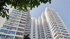 A high-rise building with multiple balconies and a modern architectural design.