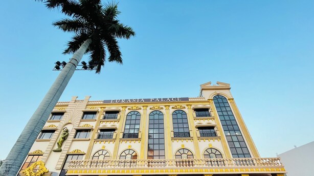 A large, ornate building with the name 'Eurasia Palace' on the facade.