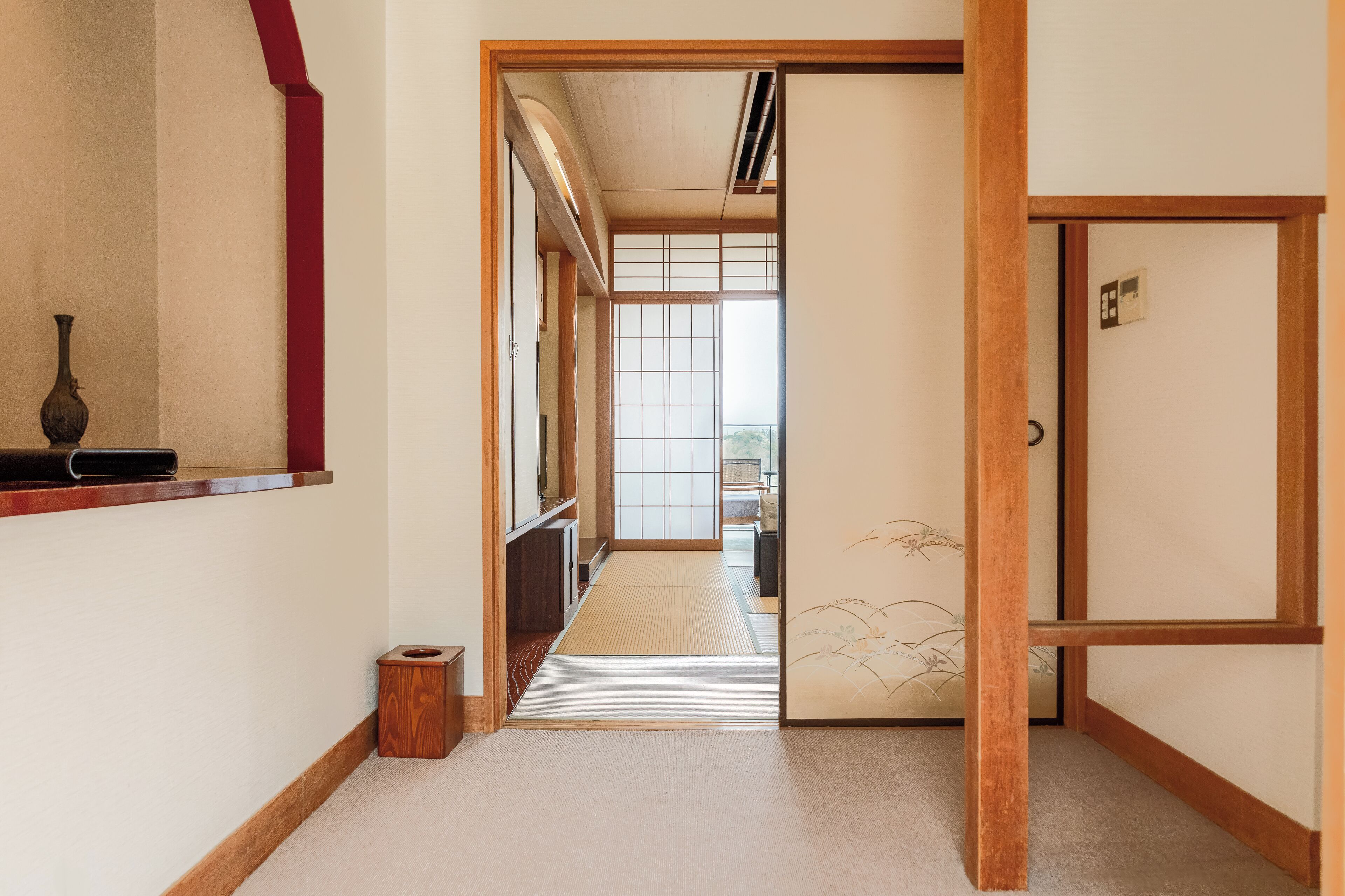 A traditional Japanese interior with tatami flooring, sliding doors, and a minimalist design.