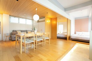 A modern interior with a dining area, a sofa, a bed, and a bathroom. - HOTEL ReONcE Shibuya (Tokyo)