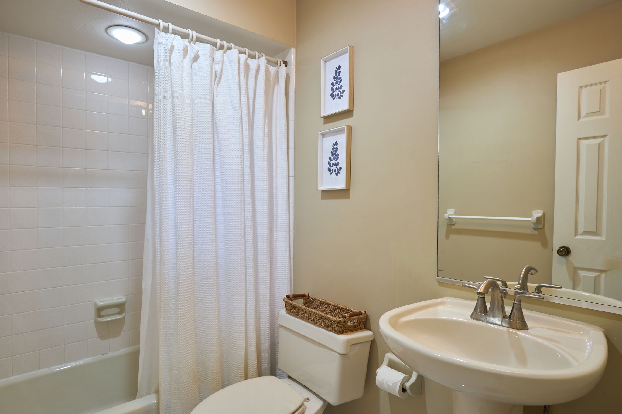 Third bathroom with shower/tub combo and single pedestal vanity