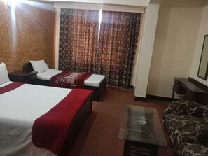 Two single beds, a sofa, and a coffee table make this room a comfortable retreat.