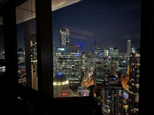A cityscape at night with illuminated buildings, including a Marriott hotel.