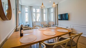 A dining area with a wooden table, woven placemats, and wicker chairs.