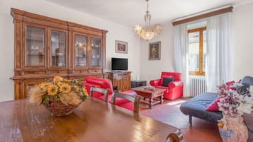 Apartamento, vistas a la ciudad | Zona de estar | Televisión de 32 pulgadas con canales por cable