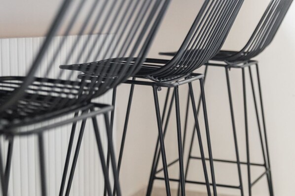 A close-up of black metal chairs with a modern design.