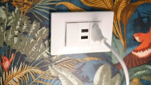 A white electrical outlet with two USB ports on a patterned wall. - Neapolitan Soul 1 By Dimorra (Napoli)
